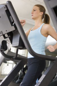 Woman Walking on Treadmill --- Image by © Royalty-Free/Corbis